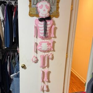 Kirklands Pink and White Hanging Skeleton Door Decor